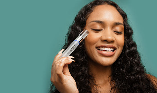 Model holding neuLASH with eyes closed on a green background