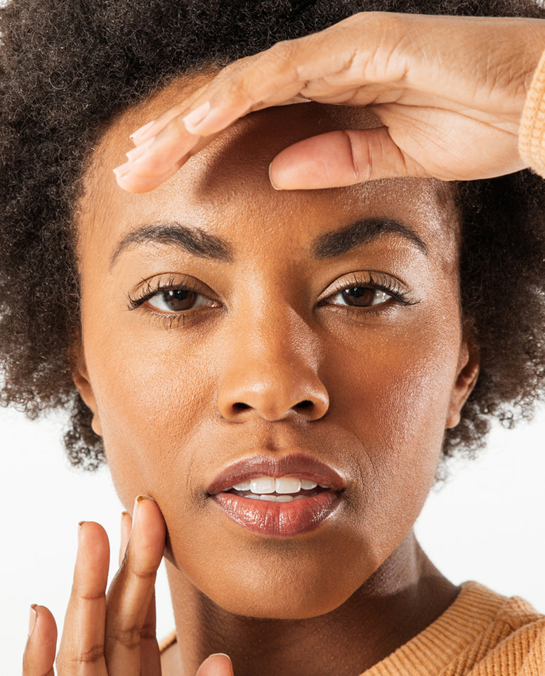 Model posing at camera with model on forehead