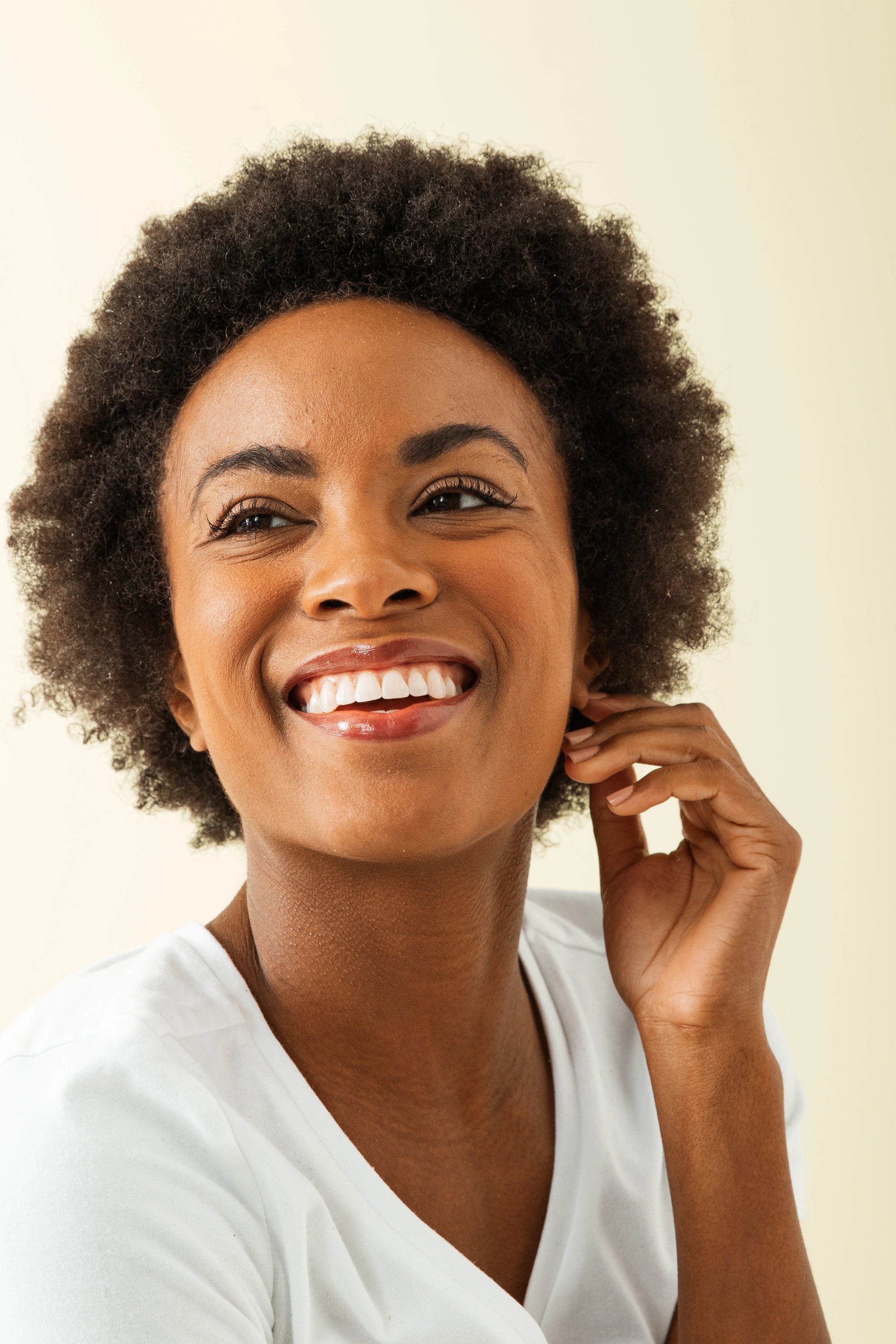 Model in white shirt smiling off camera